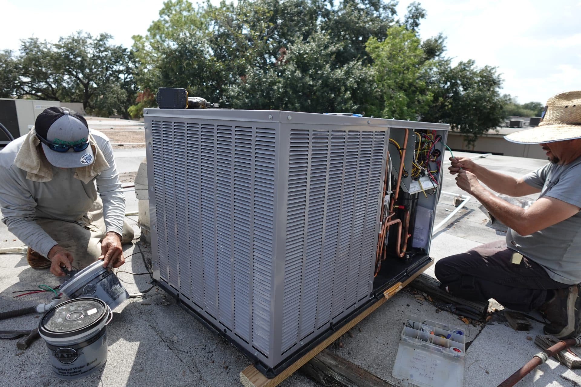 TruFlo technicians installing a commercial HVAC system on a rooftop