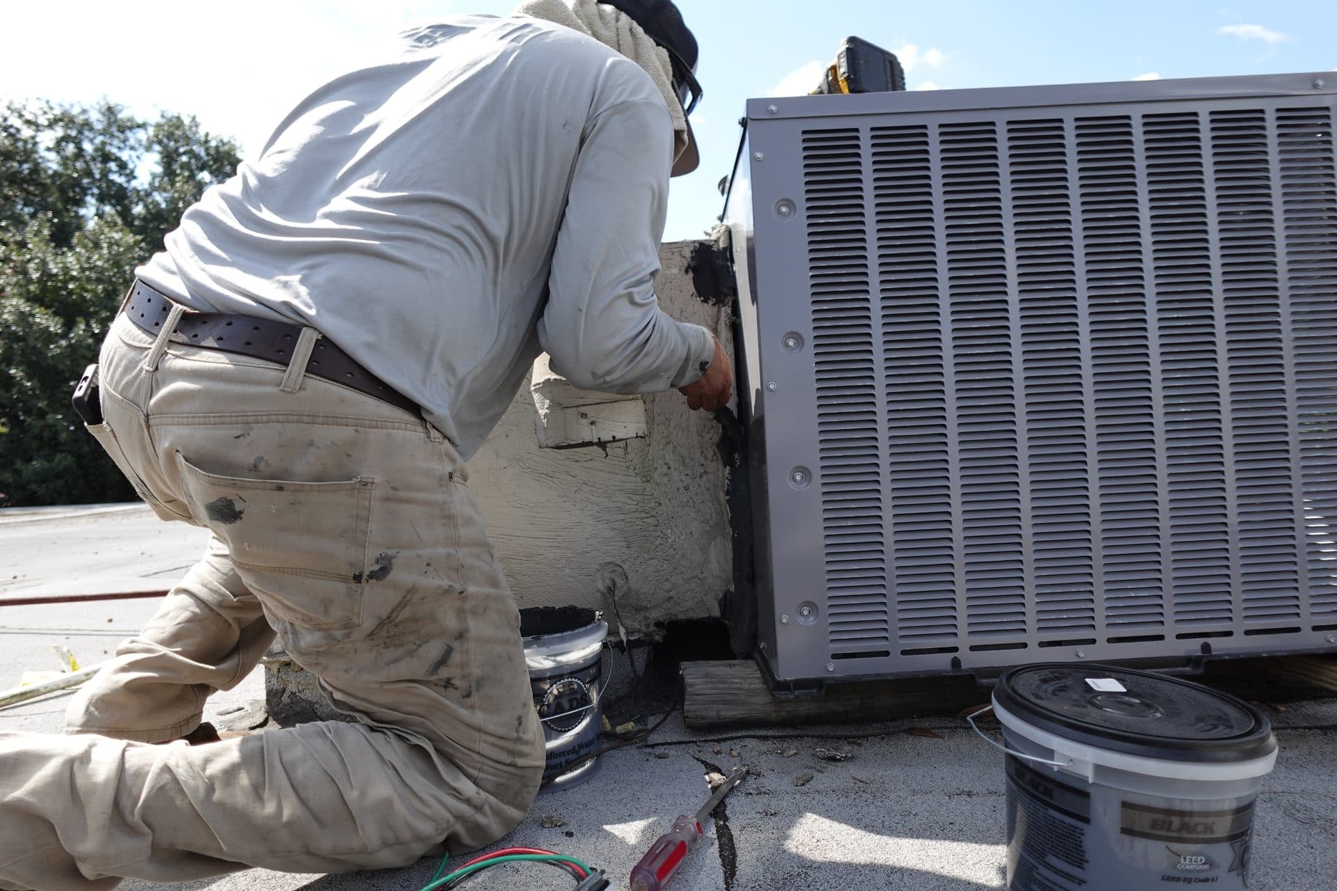 Technician servicing an outdoor AC unit