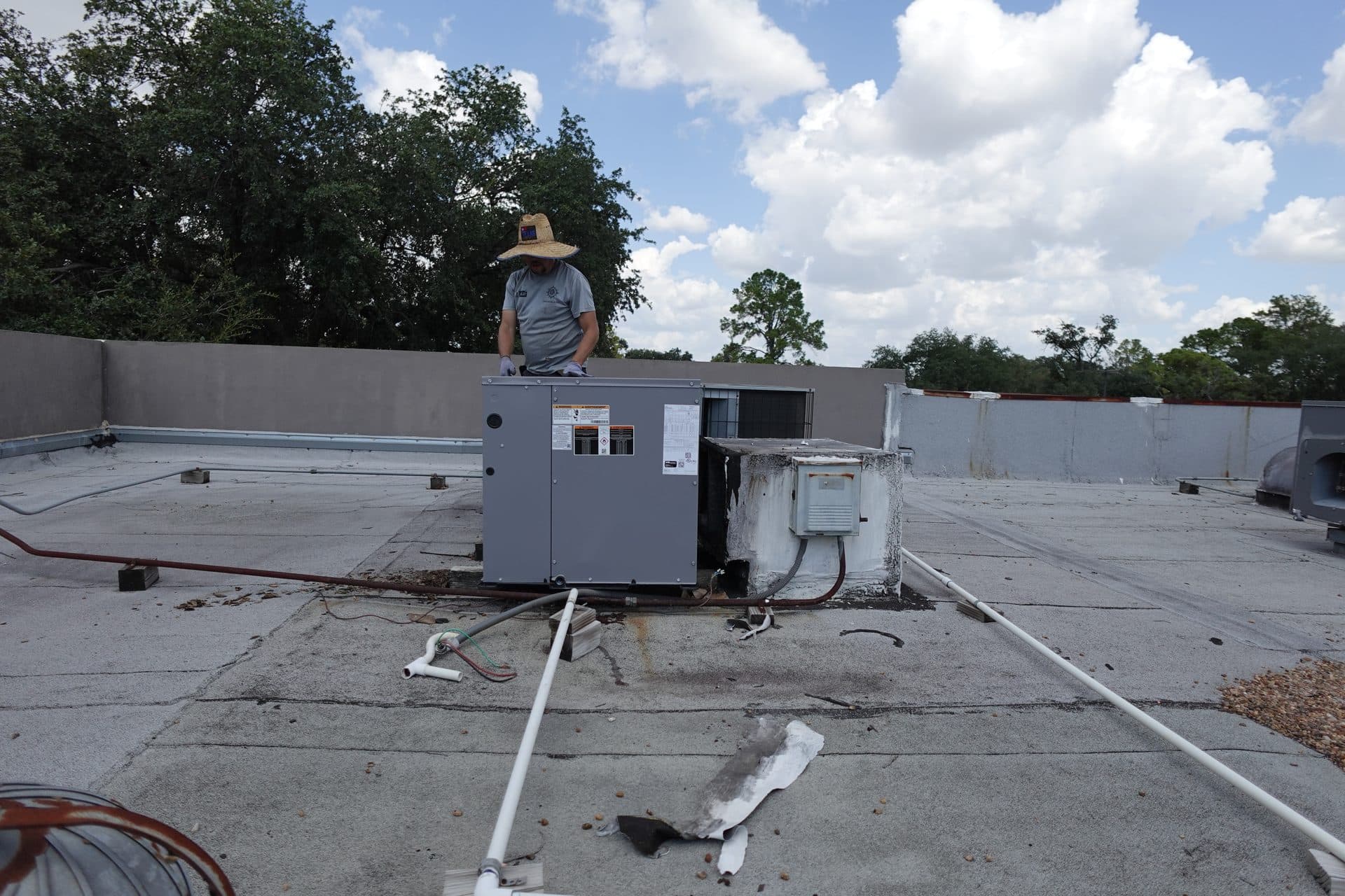TruFlo technician performing HVAC maintenance on a rooftop unit